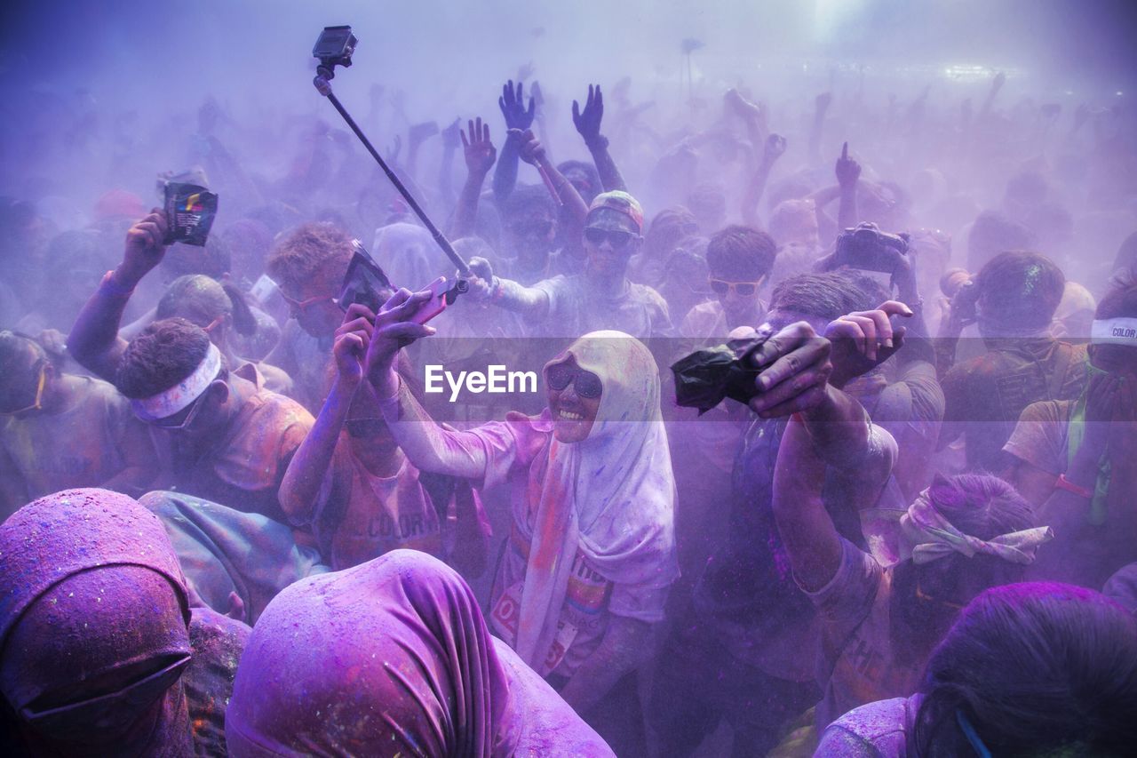 Crowd playing holi