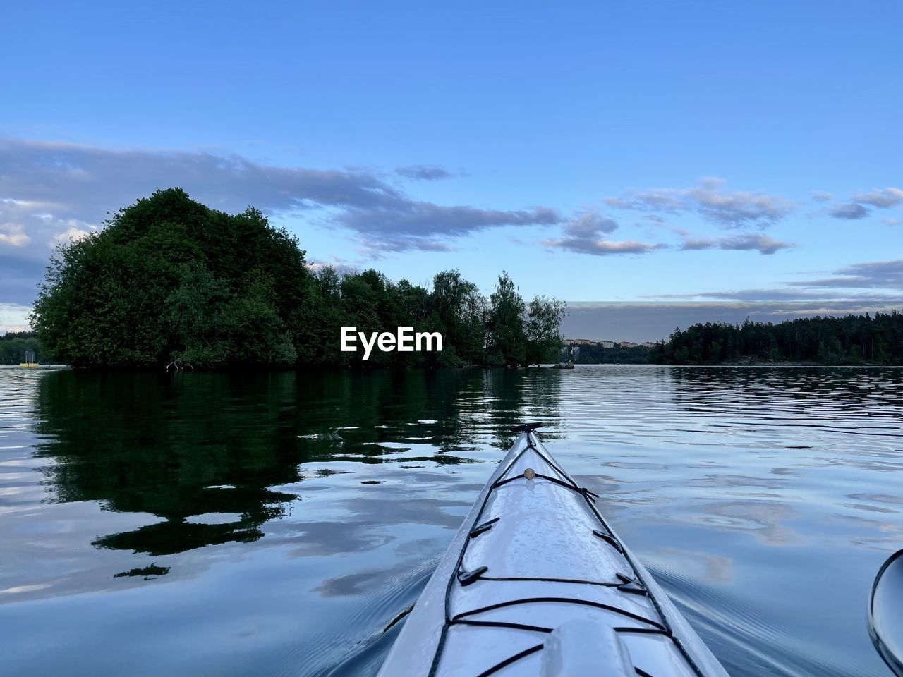 water, tree, boat, sky, boating, vehicle, nature, plant, reflection, lake, scenics - nature, nautical vessel, beauty in nature, tranquility, cloud, transportation, kayak, watercraft, tranquil scene, no people, outdoors, canoe, day, environment, travel, paddle, blue, mode of transportation, non-urban scene, landscape, forest, land, travel destinations