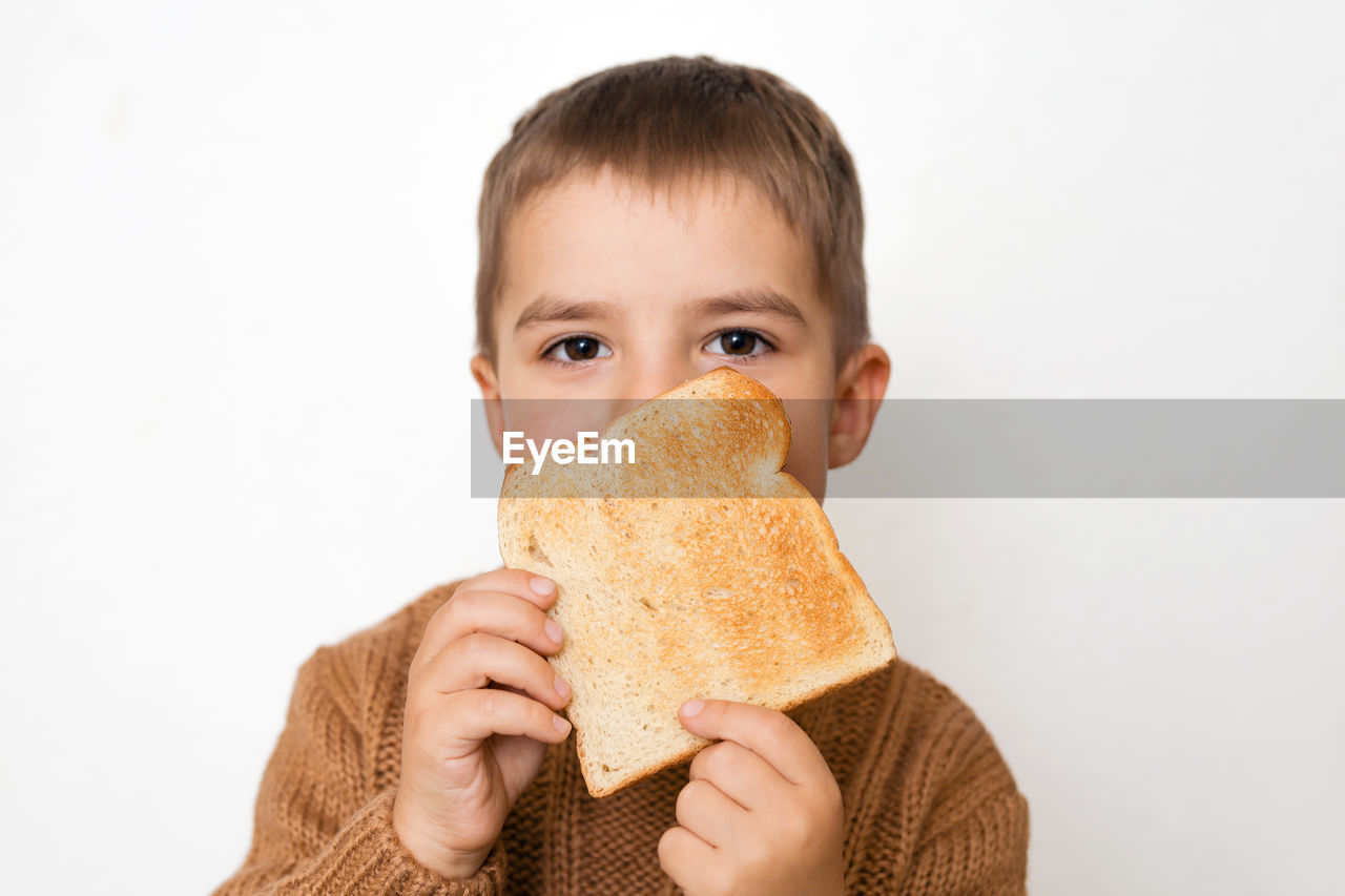 Children and gluten. preschool boy with toasted bread. gluten intolerance by kids. 