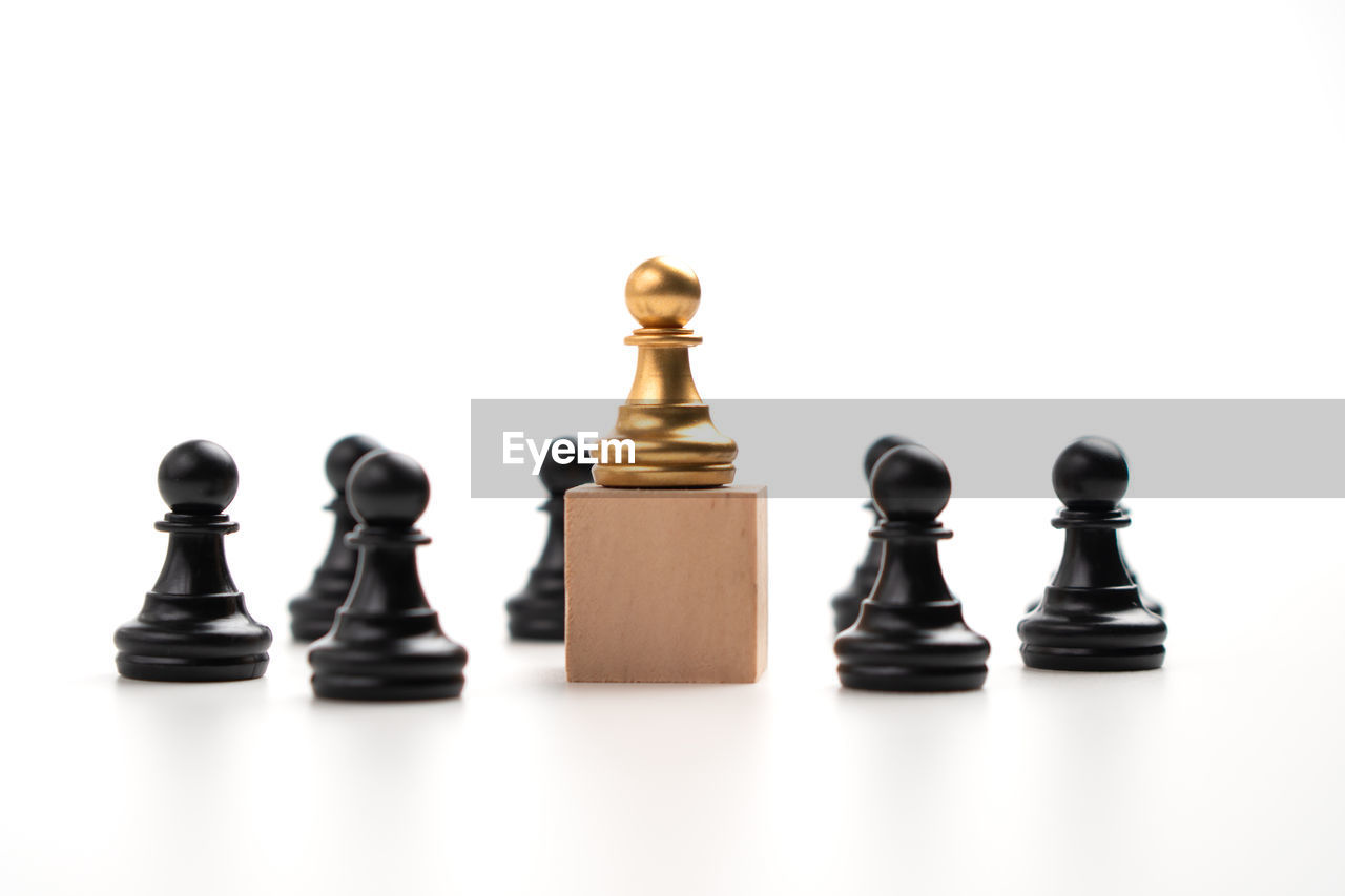 The leadership of the golden chess pawn standing on the box show influence and empowerment.