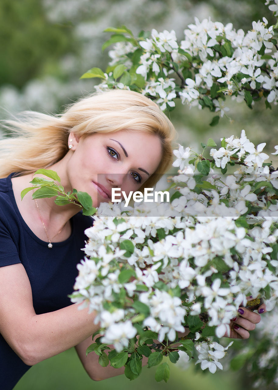 Portrait of beautiful woman by flowers