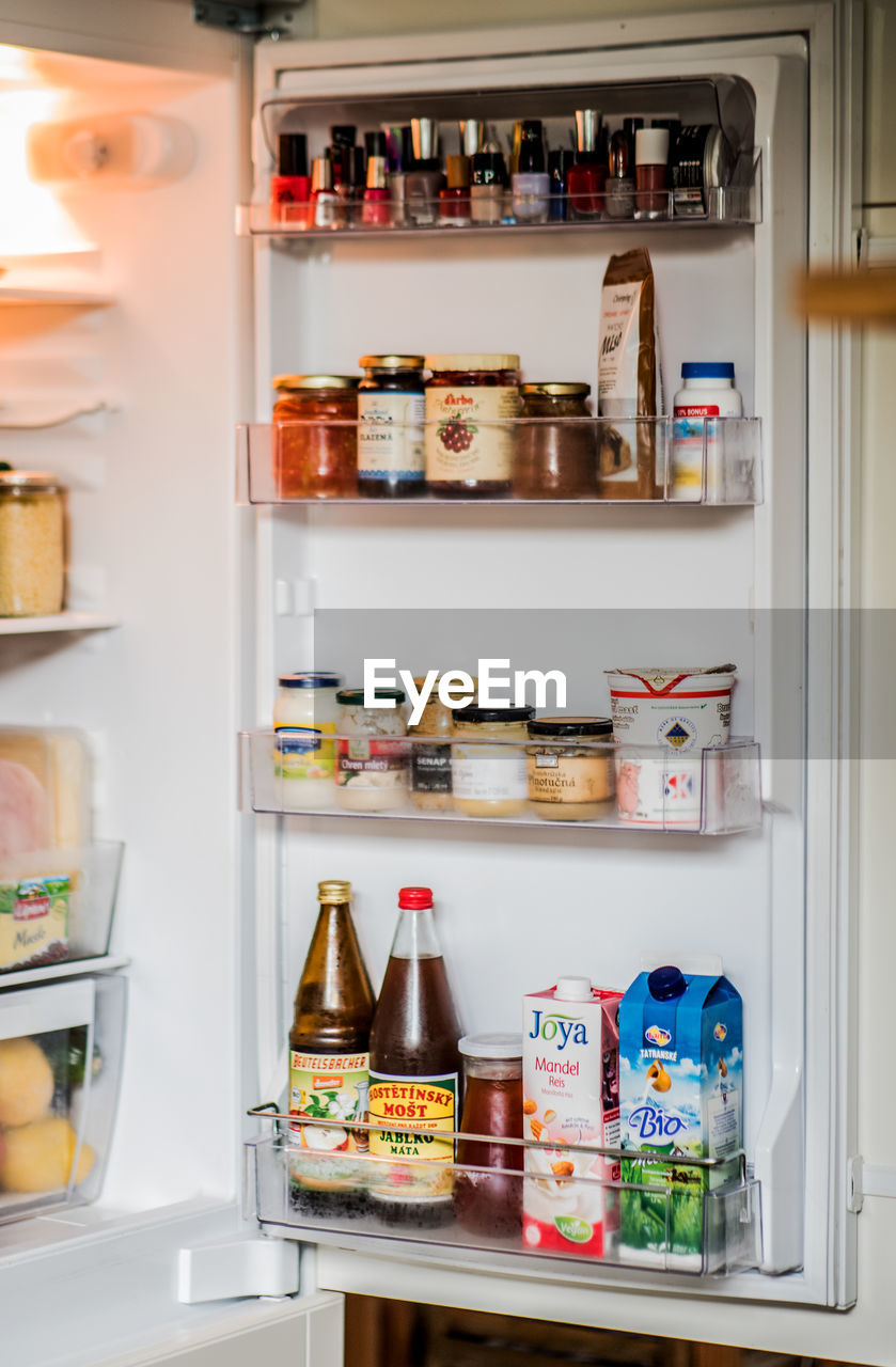 BOTTLES ON SHELF AT KITCHEN