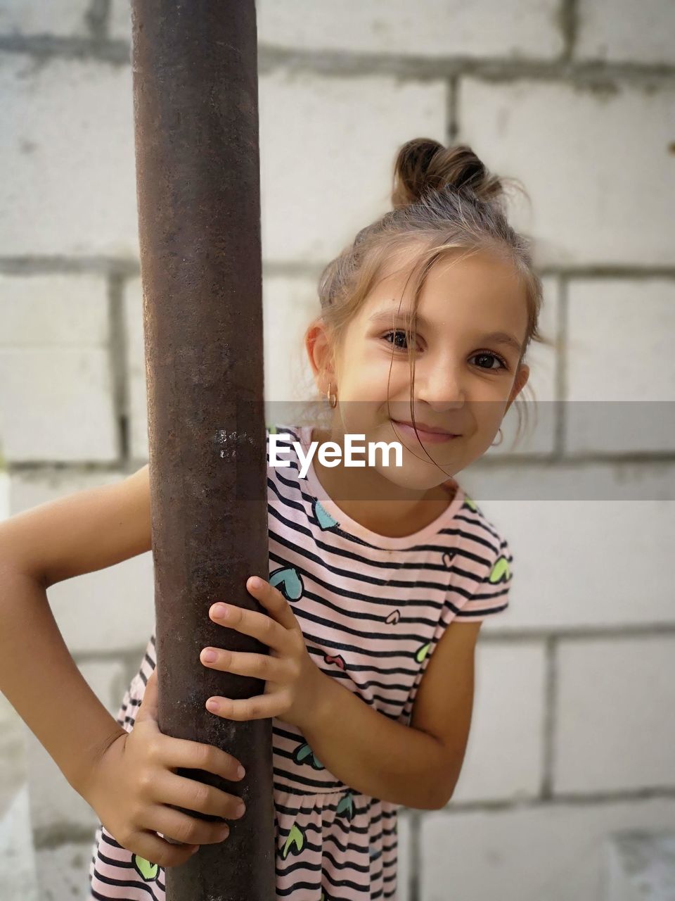 Portrait of smiling girl standing outdoors