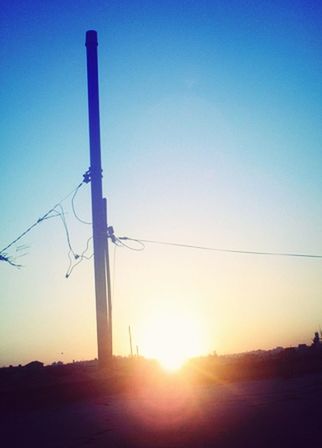 SILHOUETTE OF POWER LINES AT SUNSET