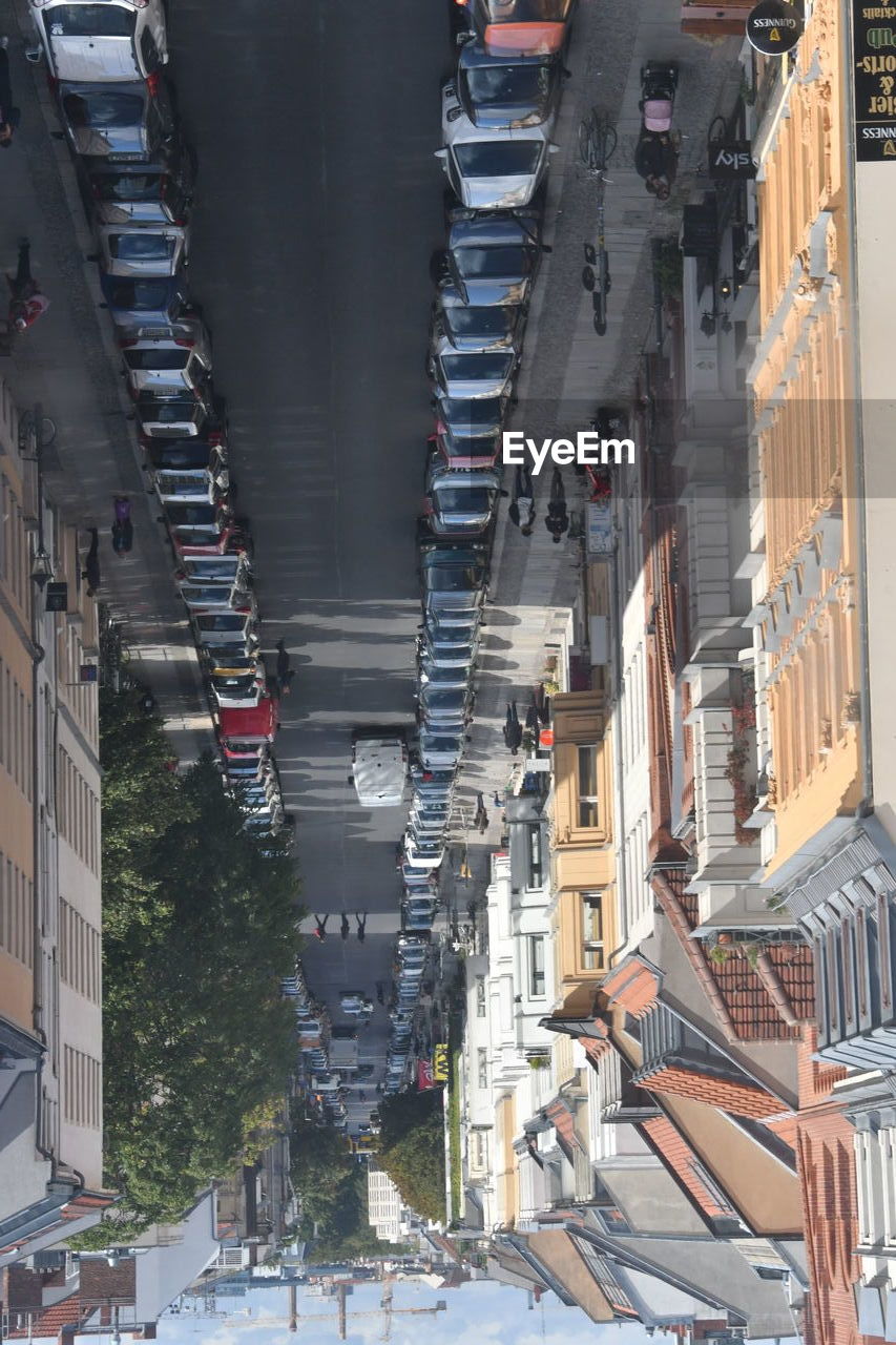 High angle view of vehicles on road amidst buildings in city