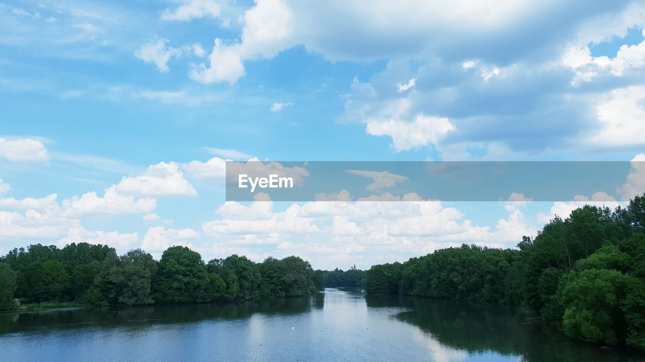 PANORAMIC VIEW OF TREES BY LAKE AGAINST SKY