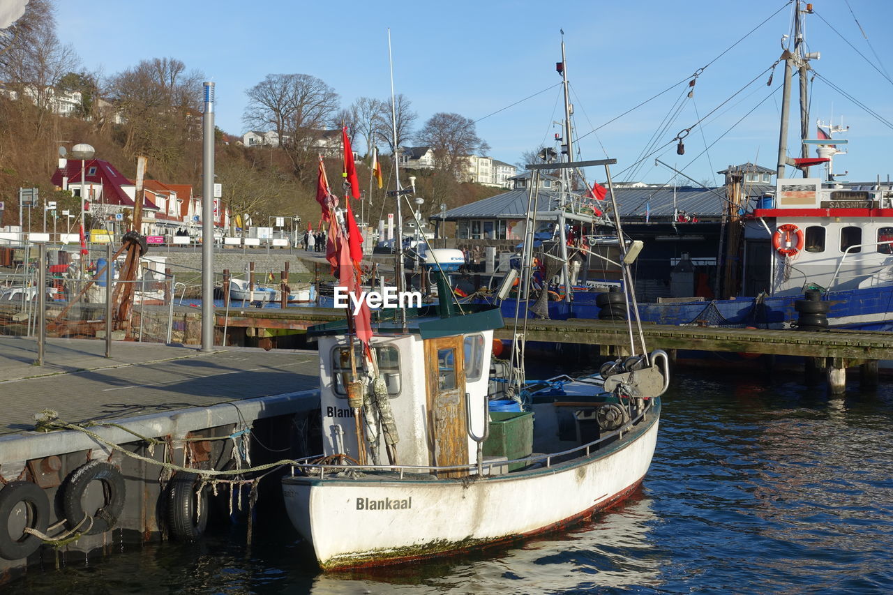 BOATS MOORED IN HARBOR