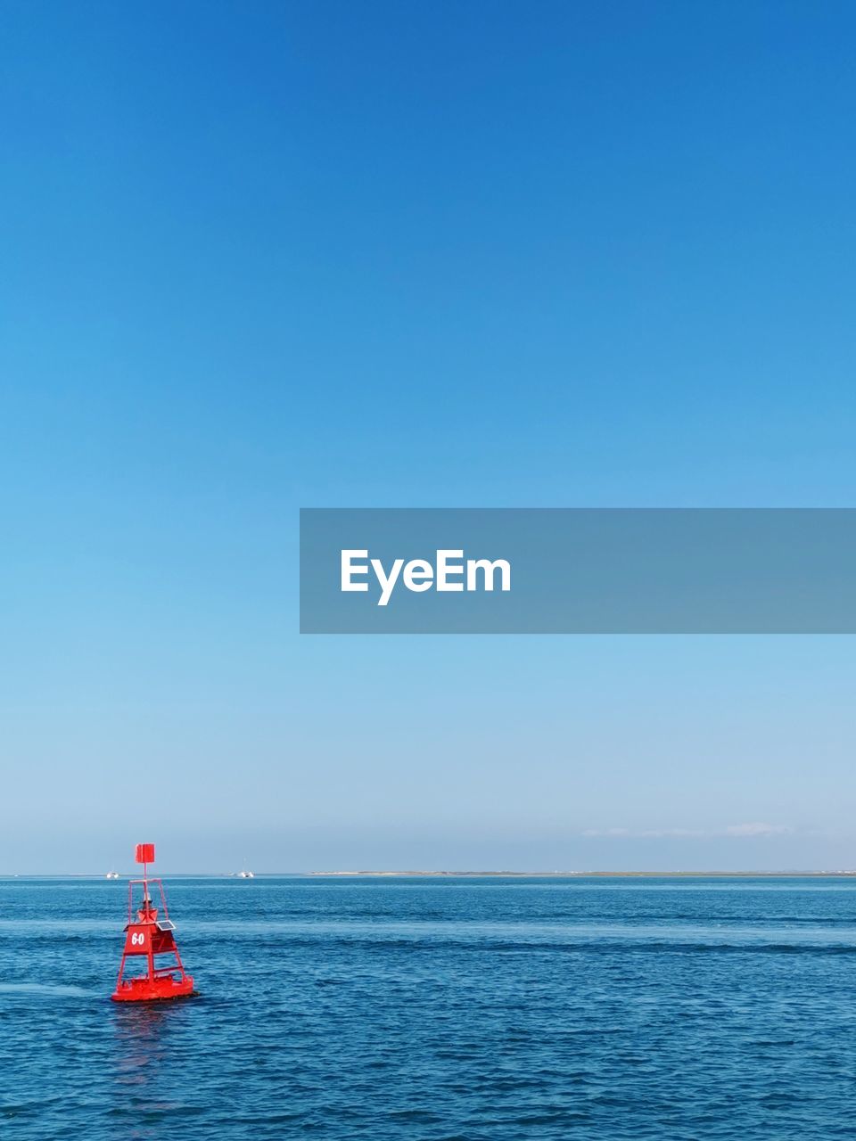 Scenic view of lagoon against clear blue sky. 