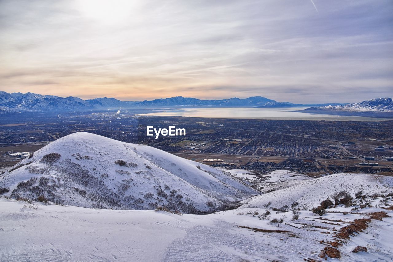 snow, cold temperature, winter, environment, scenics - nature, landscape, mountain, beauty in nature, sky, mountain range, nature, cloud, tranquility, snowcapped mountain, tranquil scene, travel destinations, no people, travel, frozen, non-urban scene, ice, land, tourism, plateau, polar climate, idyllic, outdoors, ridge, remote, day, white, extreme terrain, sunset, summit, water