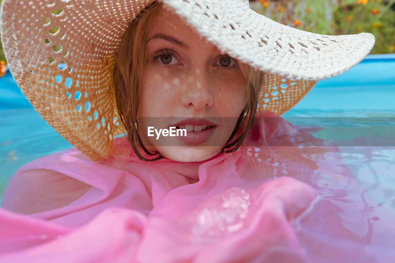 Portrait of beautiful woman in swimming pool