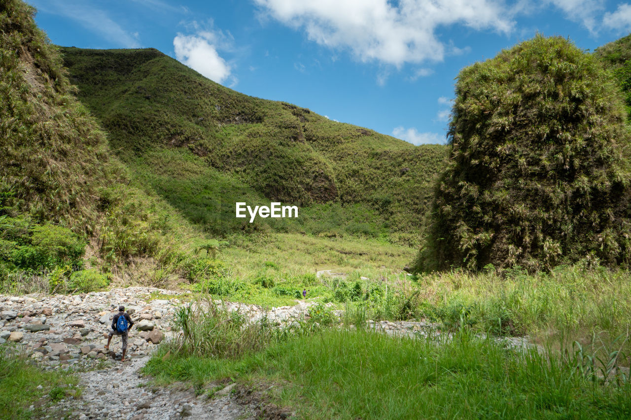 SCENIC VIEW OF FIELD AND MOUNTAIN AGAINST SKY