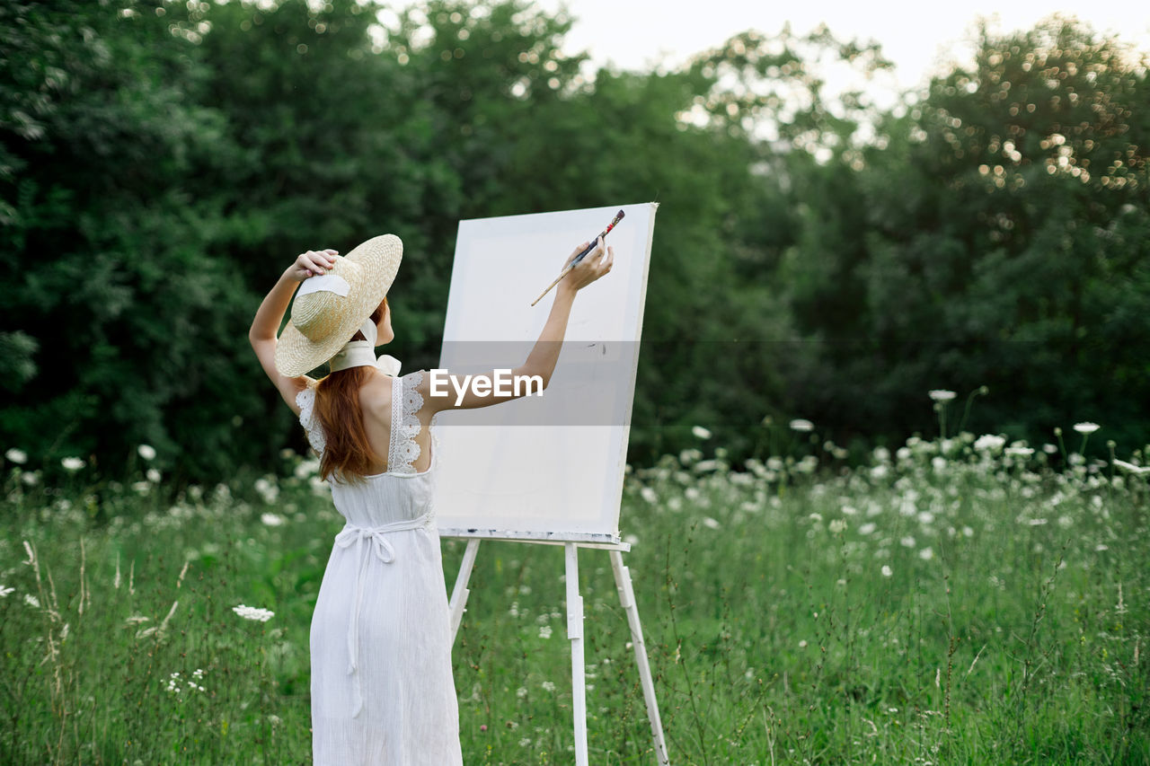 WOMAN STANDING ON FIELD