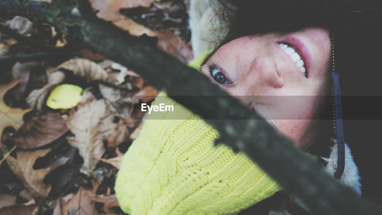 Portrait of woman looking through branch