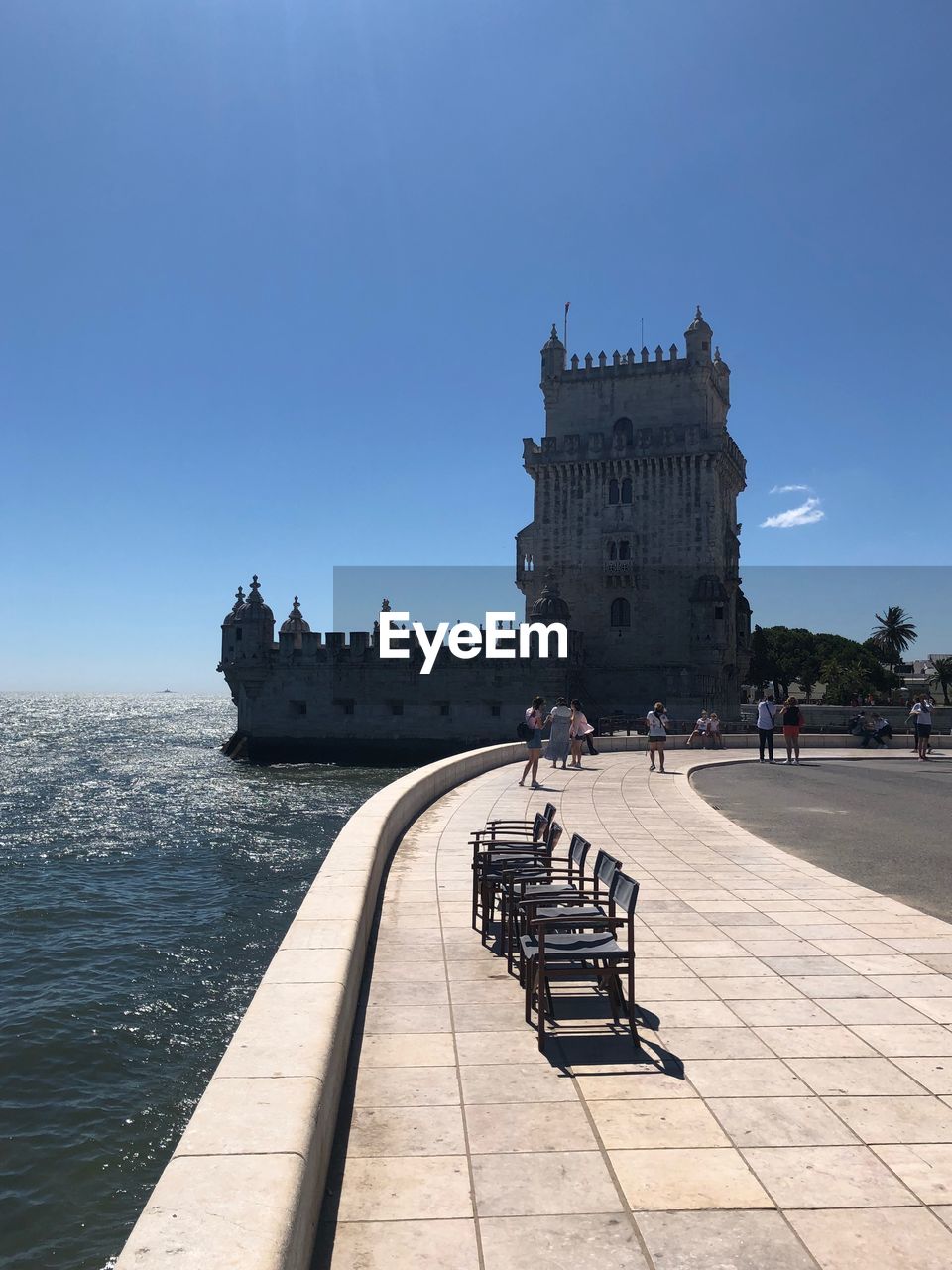 PEOPLE AT HISTORICAL BUILDING AGAINST BLUE SKY