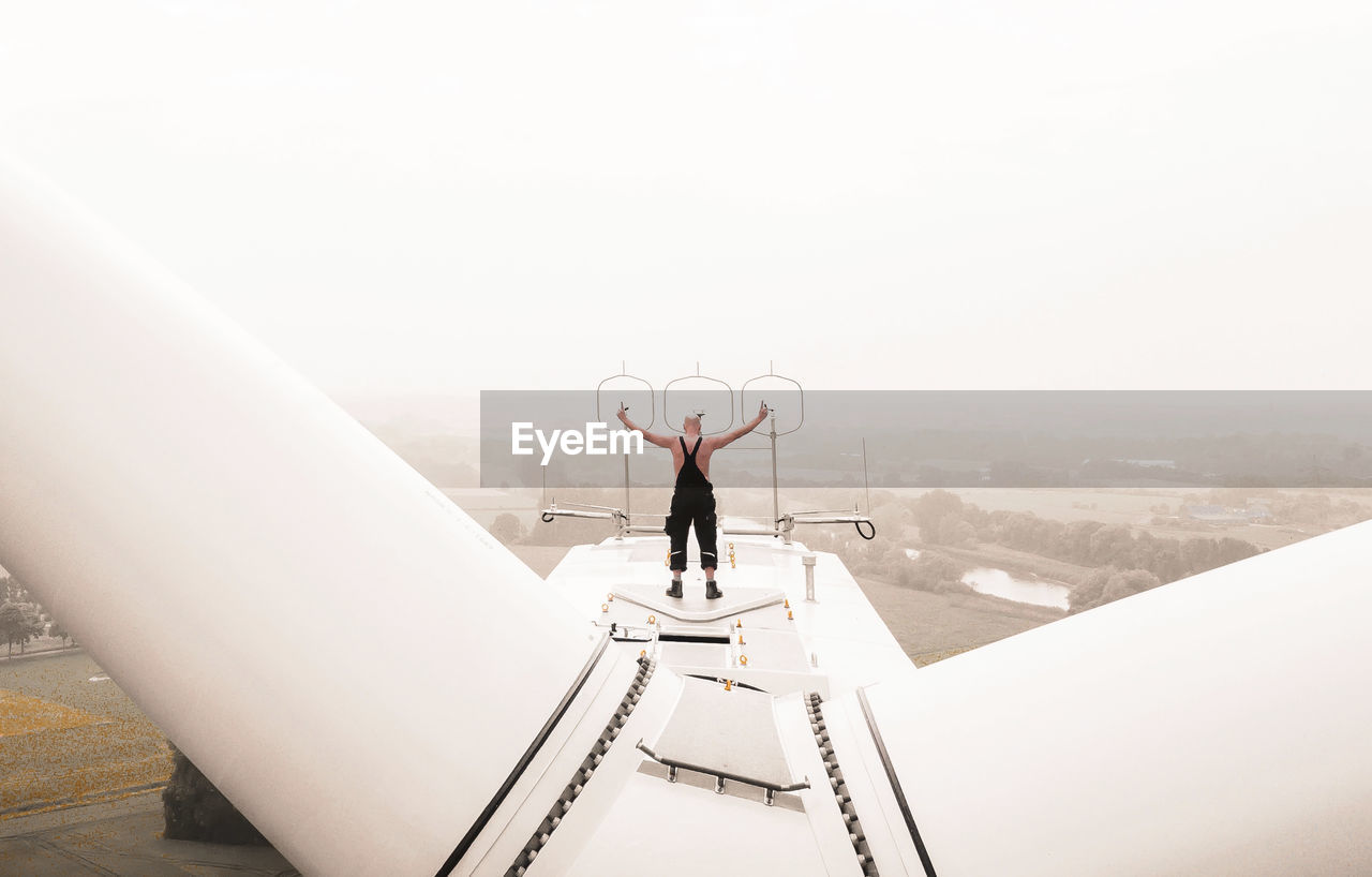 - #FREIHEIT SUSTAINABLE - The Portraitist - 2018 EyeEm Awards Check This Out DJI X Eyeem EyeEm Best Shots Wind Power Architecture Arms Raised Building Exterior Built Structure Copy Space Day Drone Photography Dronephotography Full Length Human Arm Leisure Activity Lifestyles Men Nature One Person Outdoors Real People Rear View Sky Standing Wind Power Generator #FREIHEITBERLIN The Great Outdoors - 2018 EyeEm Awards #urbanana: The Urban Playground Be Brave 50 Ways Of Seeing: Gratitude 2018 In One Photograph Humanity Meets Technology Youth Culture 2021 Inside The Mind Awards 2021: The Storyteller Awards 2021: The Portraitist