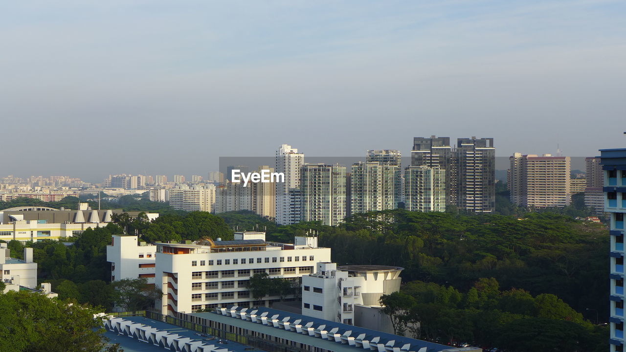 HIGH ANGLE VIEW OF BUILDINGS AGAINST SKY IN CITY