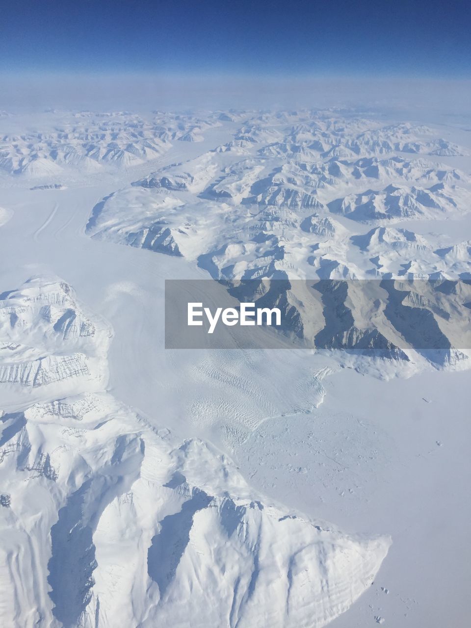Aerial photo of a snow and ice landscape with mountains 