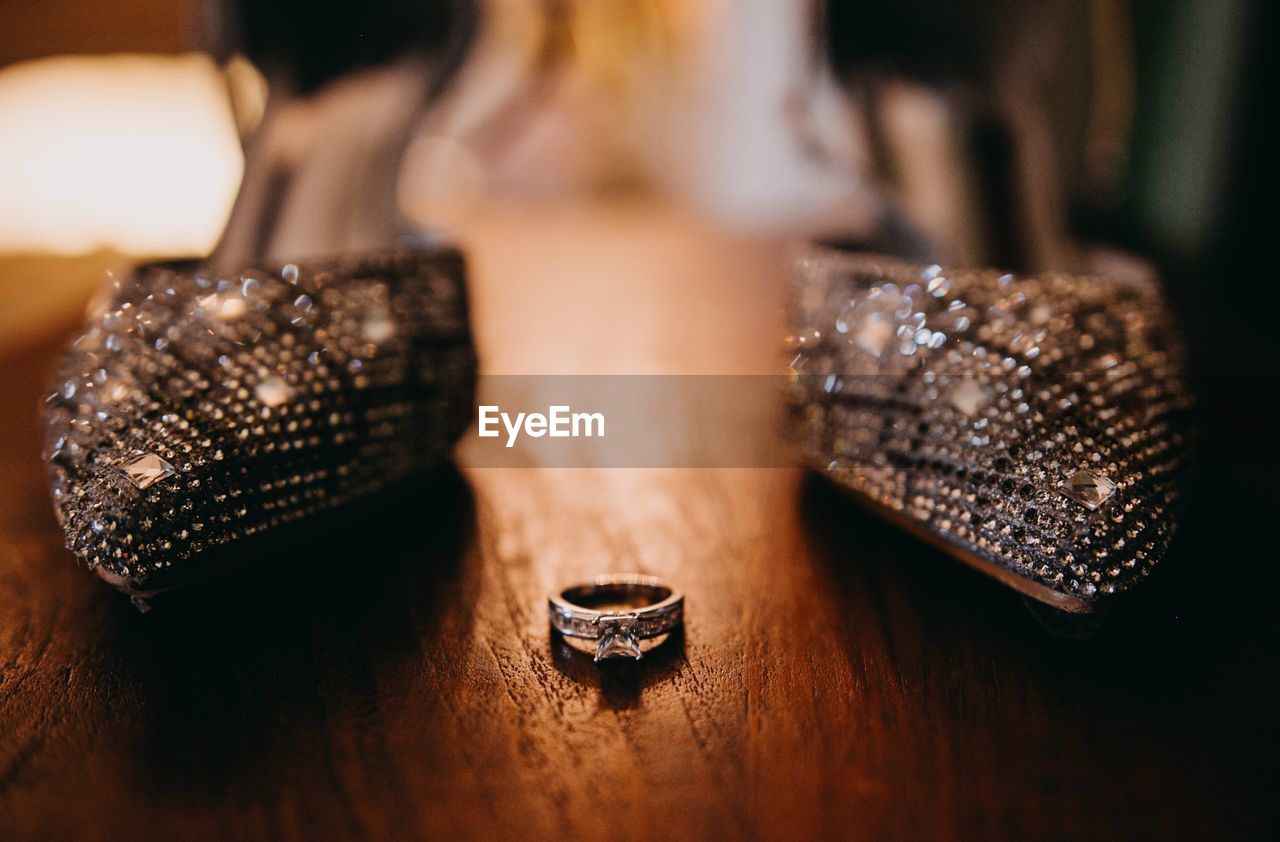 High angle view of ring and shoes on table