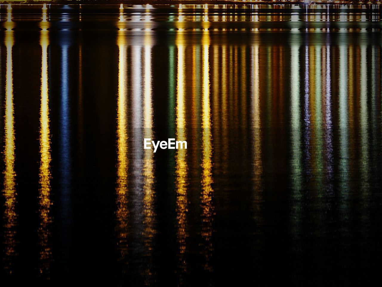 Reflection of lights in lake at night