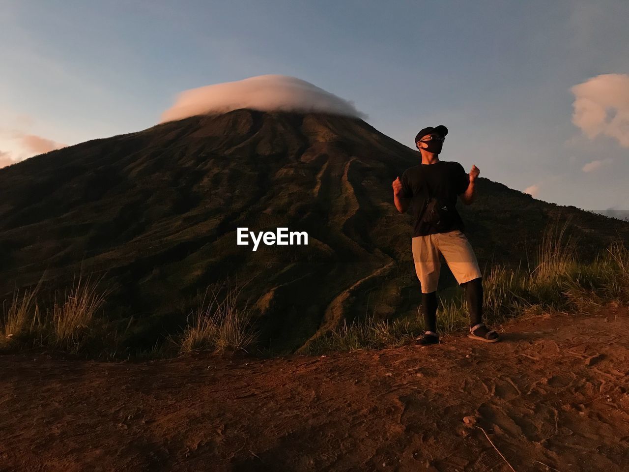 Full length of man wearing mask standing against mountain