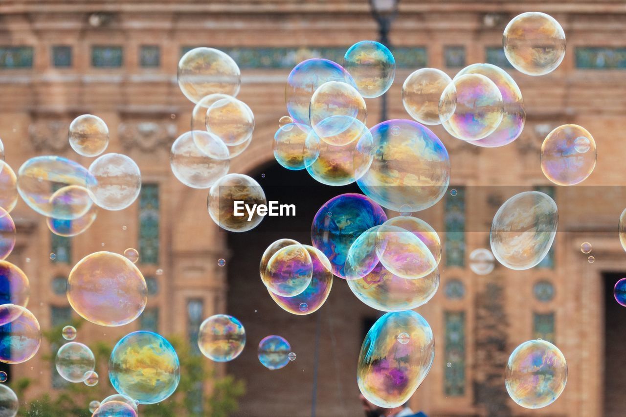 Close-up of bubbles against building in city