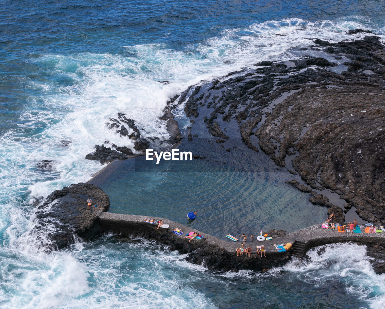 High angle view of people in a natural swimming pool in town