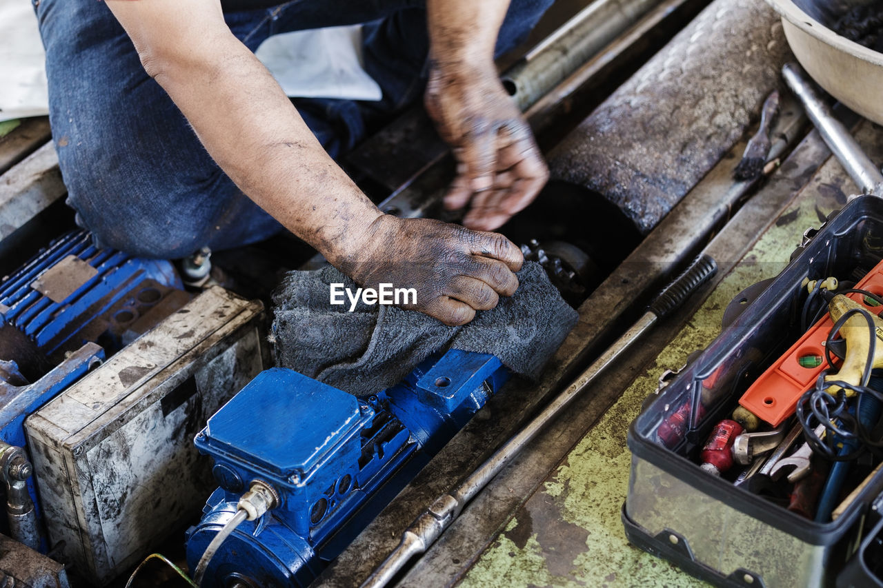 High angle view of man repairing machinery