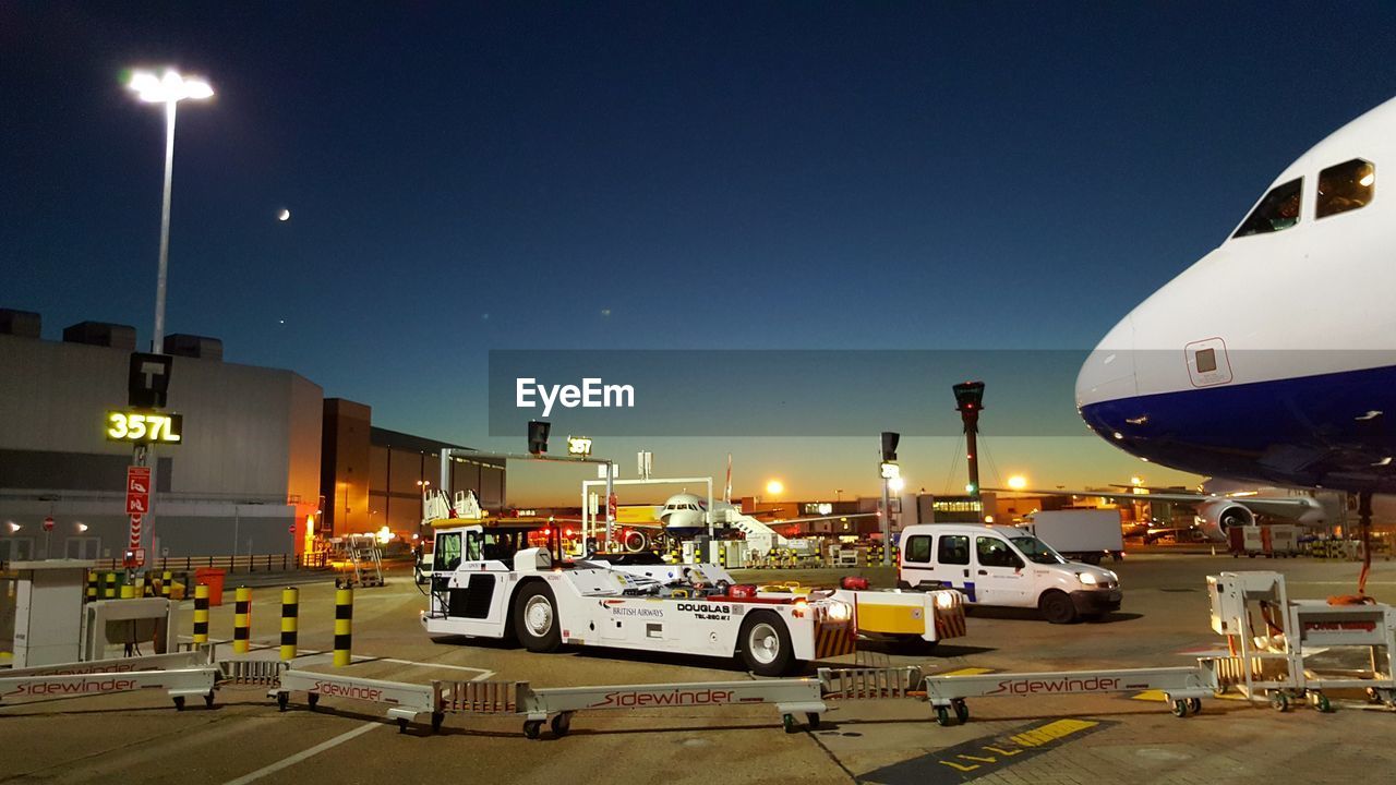 CARS ON ILLUMINATED AT NIGHT