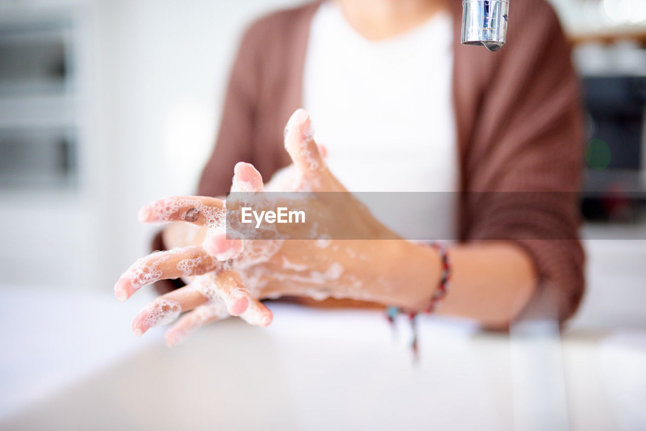 cropped hand of woman washing hands