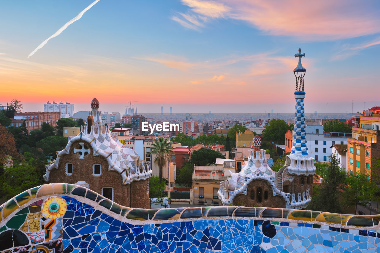 Barcelona city view from guell park. sunrise view of colorful mosaic building in park guell