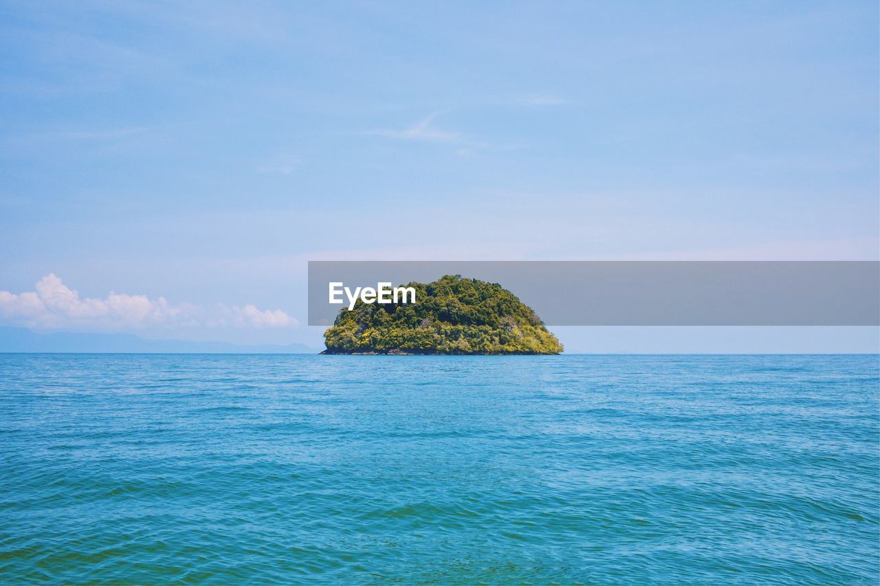 Scenic view of rocks in sea against sky