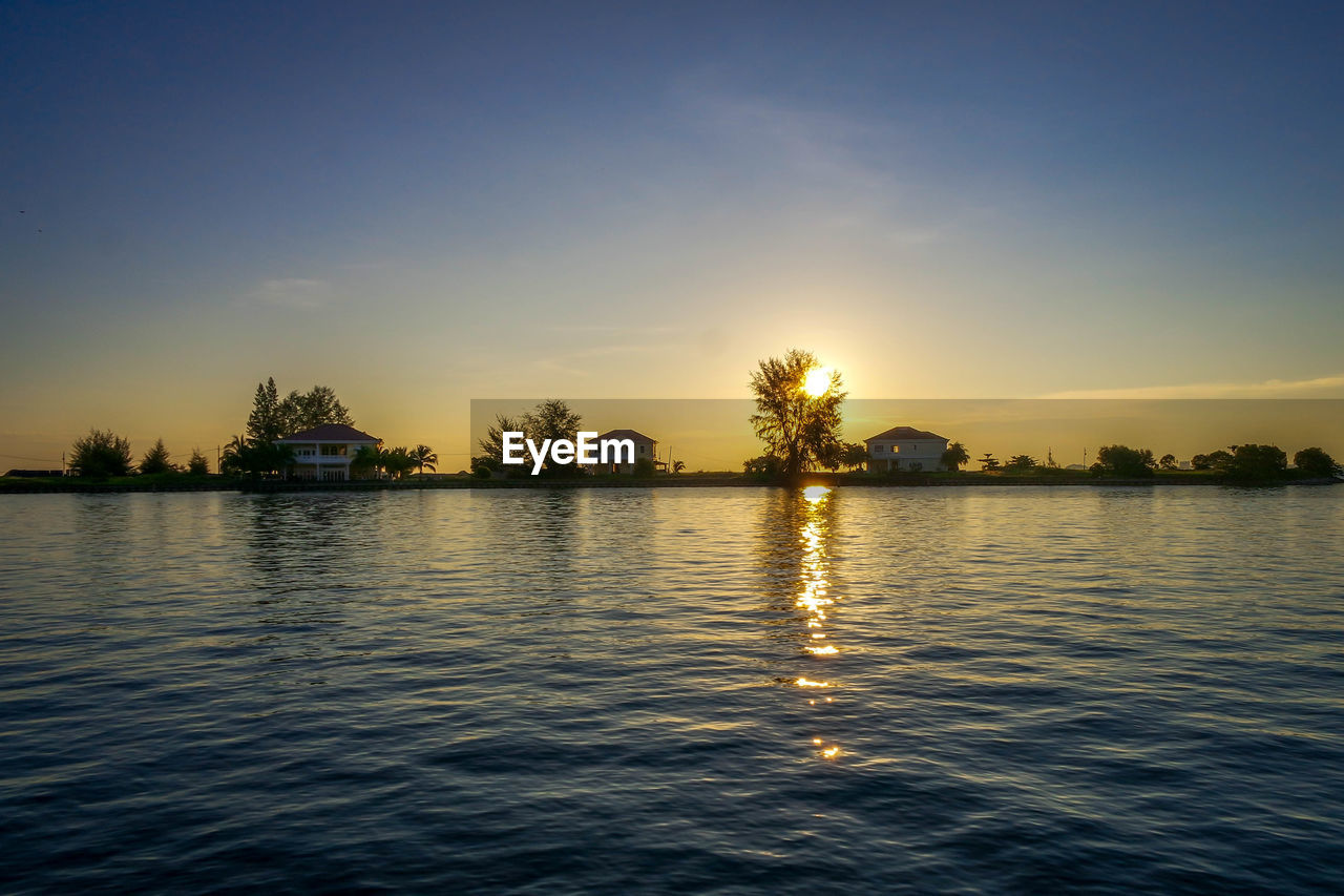 Scenic view of lake against sky during sunset