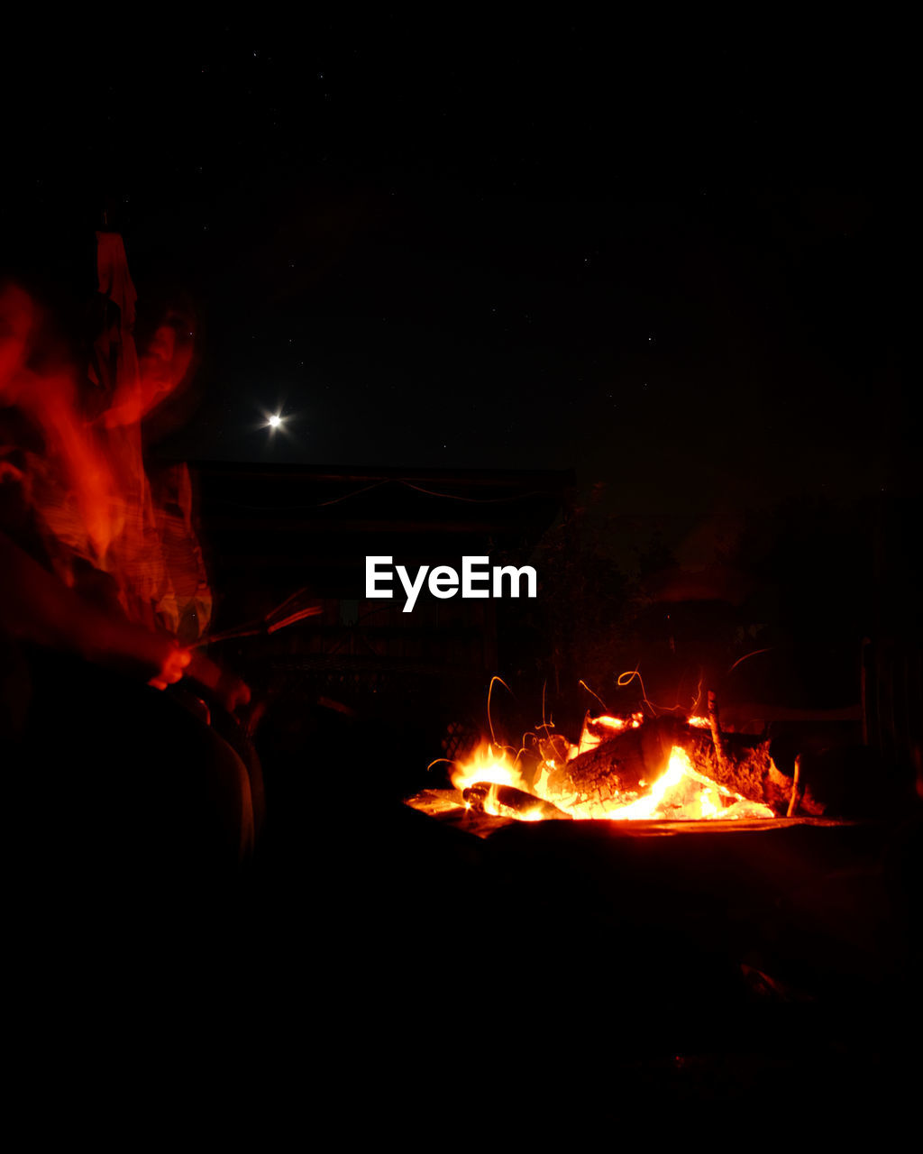 CLOSE-UP OF ILLUMINATED BONFIRE AGAINST SKY