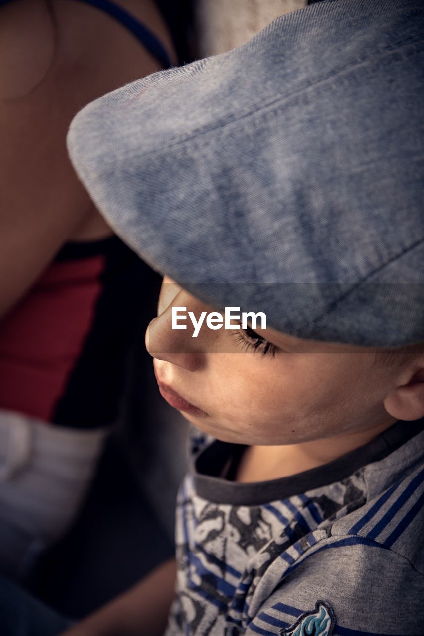 Close-up of boy wearing flat cap