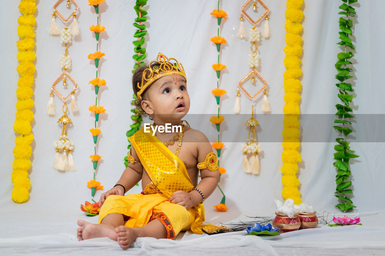 Adorable infant dressed as hindu god krishna on the occasion of janmashtami celebrated at india