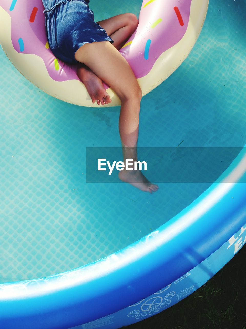 CUTE BOY PLAYING IN SWIMMING POOL