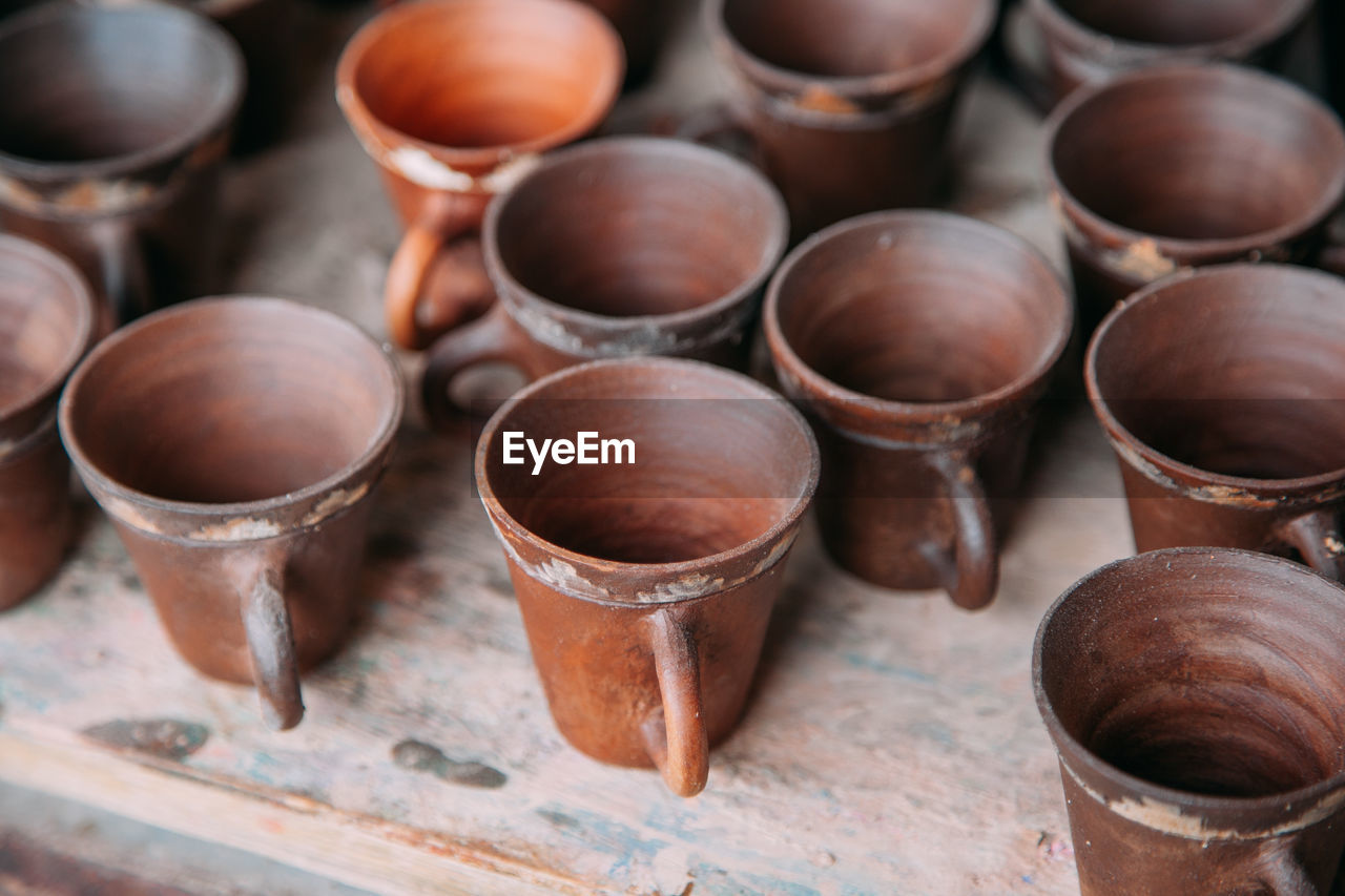 High angle view of mugs on table