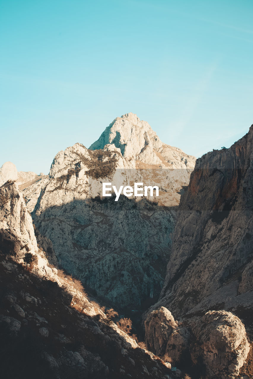 Scenic view of rocky mountains against clear sky