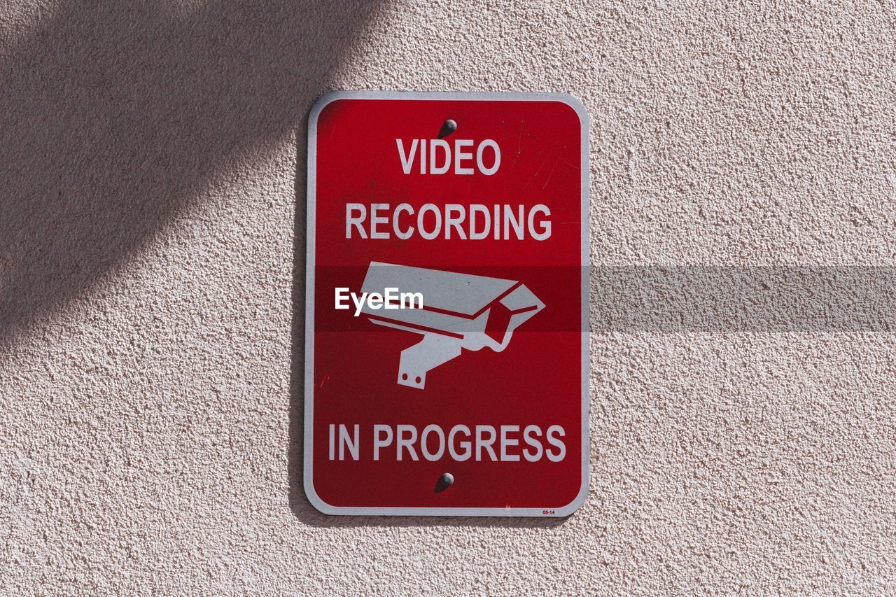 Close-up of warning sign on wall of video recording and surveillance. 