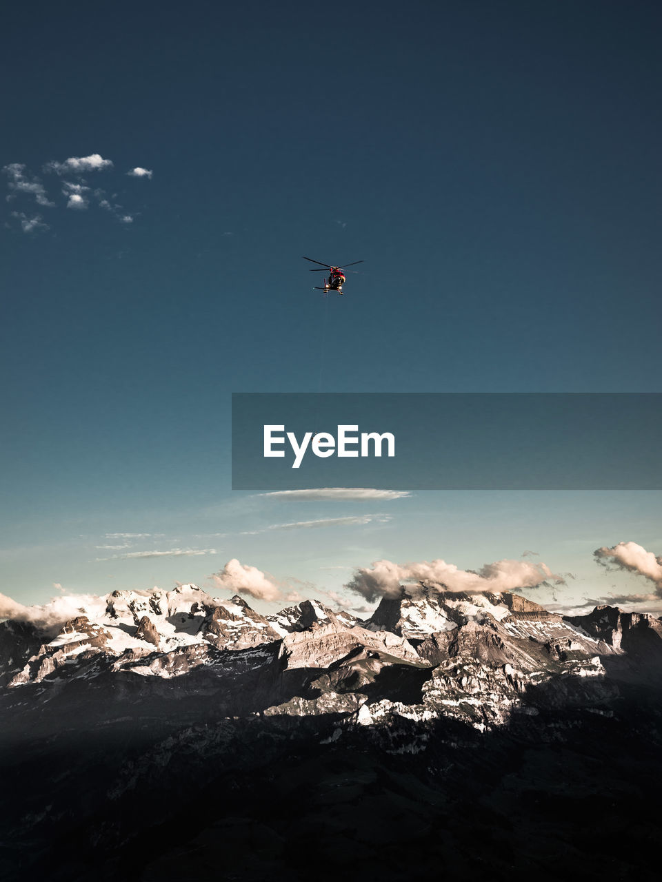 Scenic view of snowcapped mountains against blue sky