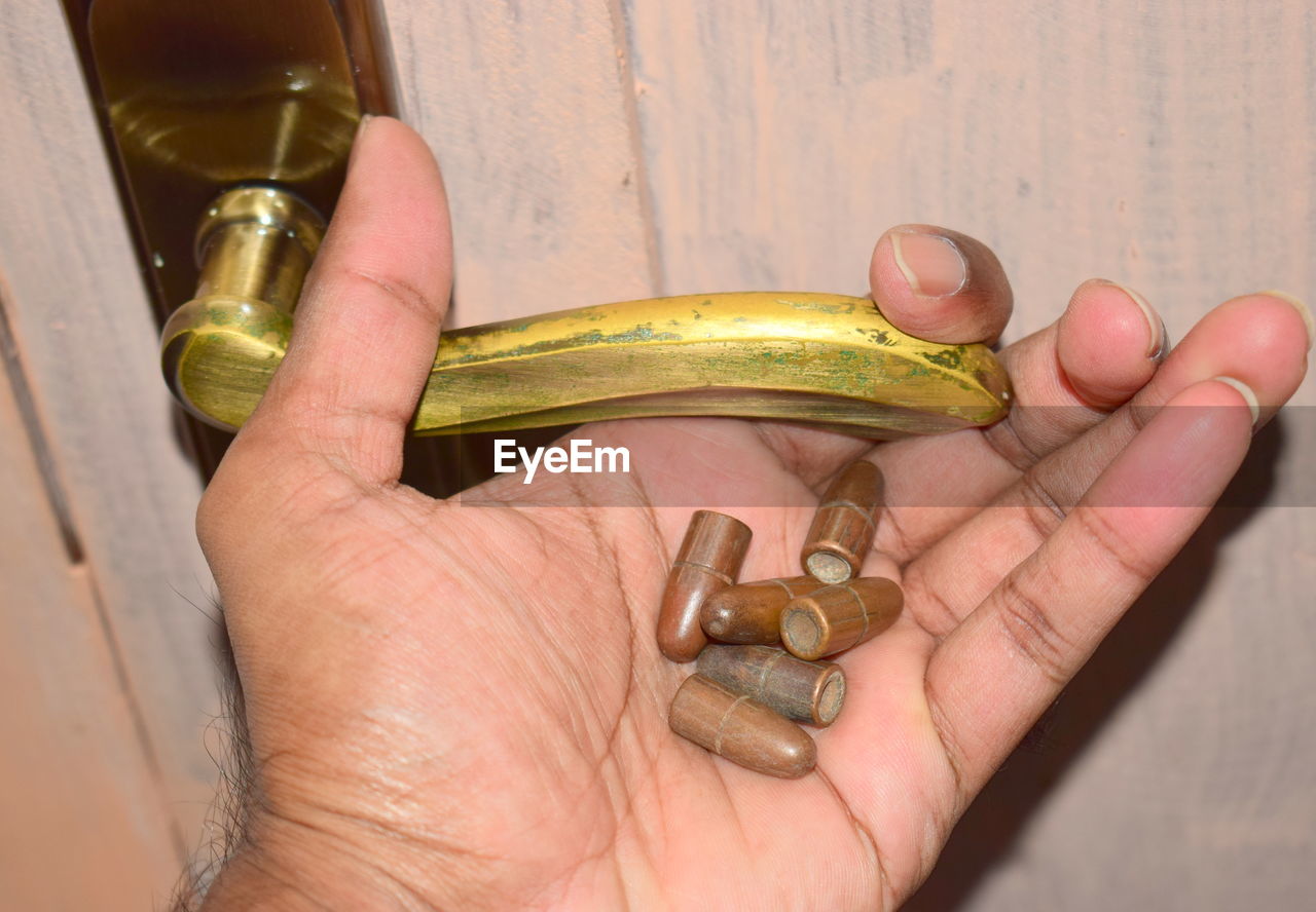 Close-up of man hand holding bullets