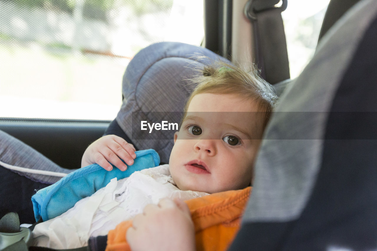 Portrait of cute baby in car