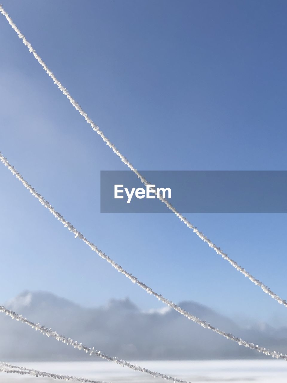 LOW ANGLE VIEW OF ROPE AGAINST CLEAR SKY