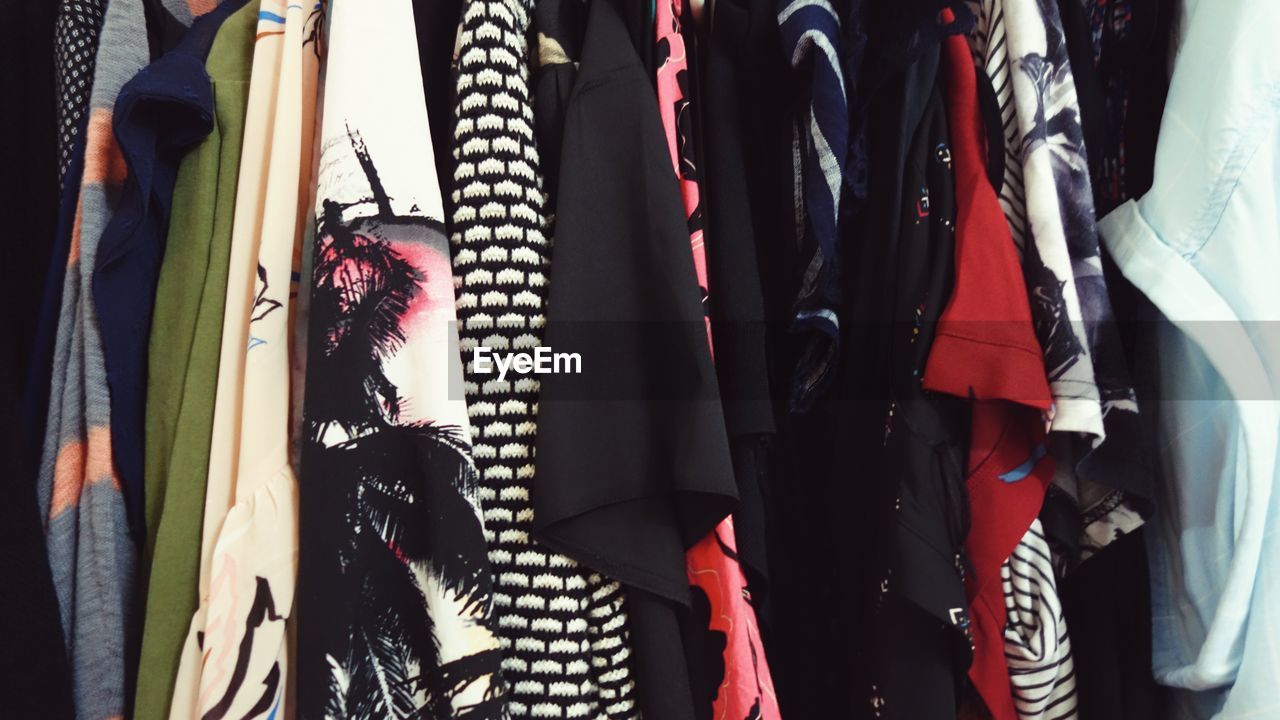 CLOSE-UP OF CLOTHES HANGING AT STORE