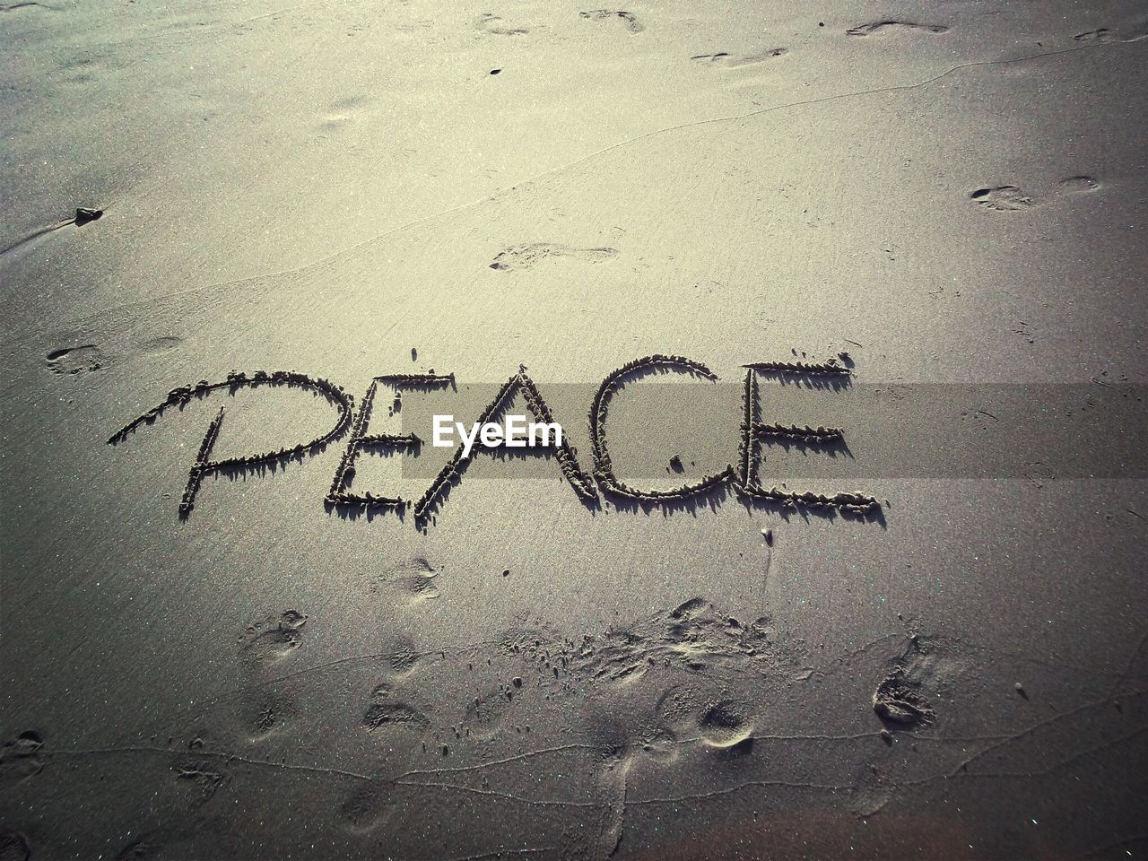 Peace written on sand at beach