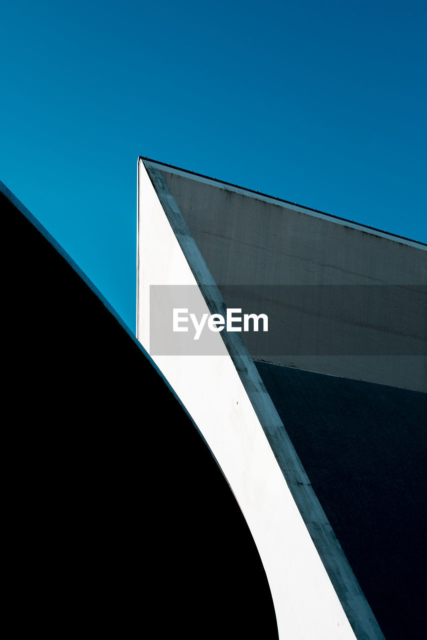 Minimalist photo of geometric shapes created by sunlight, shadows and parts of a building. 