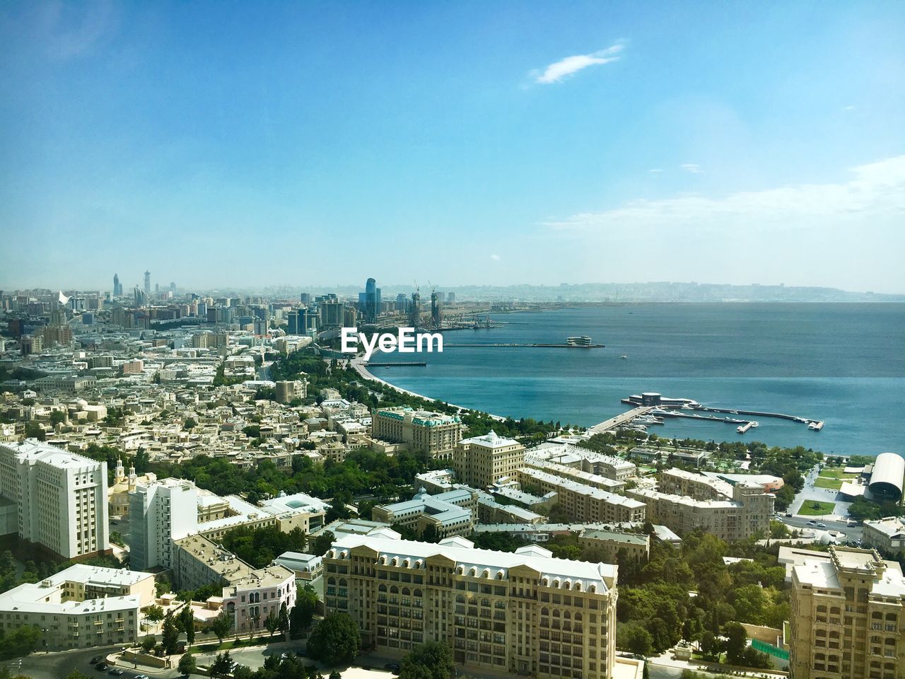 High angle view of buildings and sea against sky