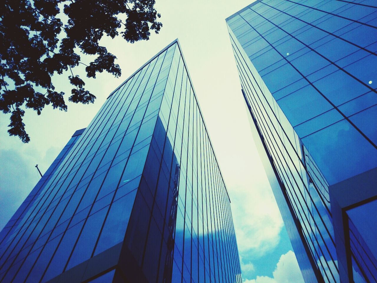 Low angle view of modern office building against sky