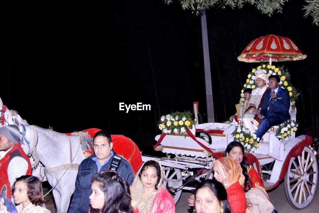 People outdoors at night during wedding