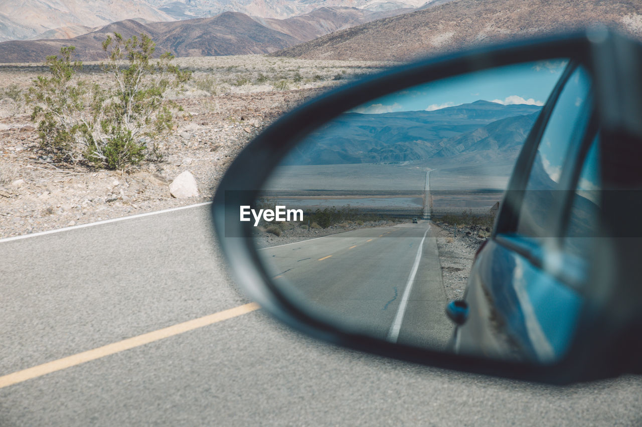 Reflection of road on side-view mirror